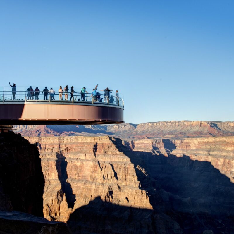 People on a skywalk over a canyon.