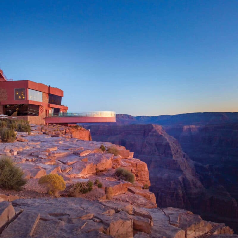 Modern building with skywalk by a canyon.