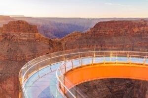 Glass horseshoe-shaped Grand Canyon Skywalk extending over a red-rock canyon.