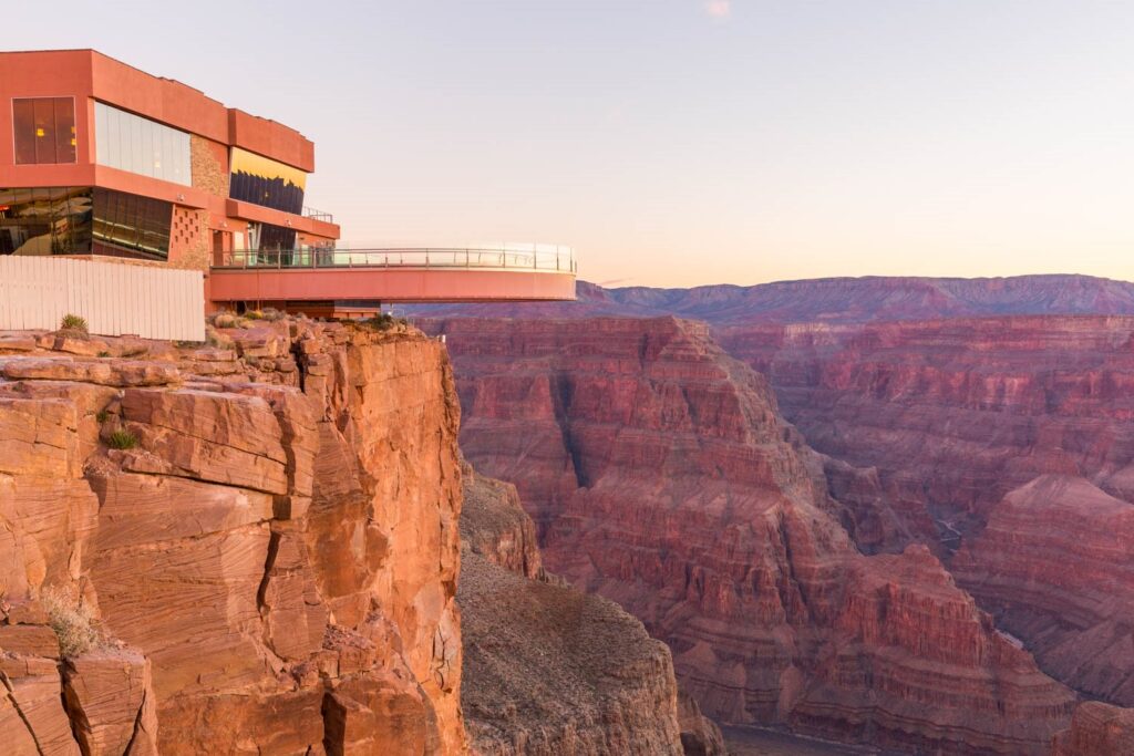 Skywalk A glass skywalk extends from a modern building over the Grand Canyon at sunset or sunrise.